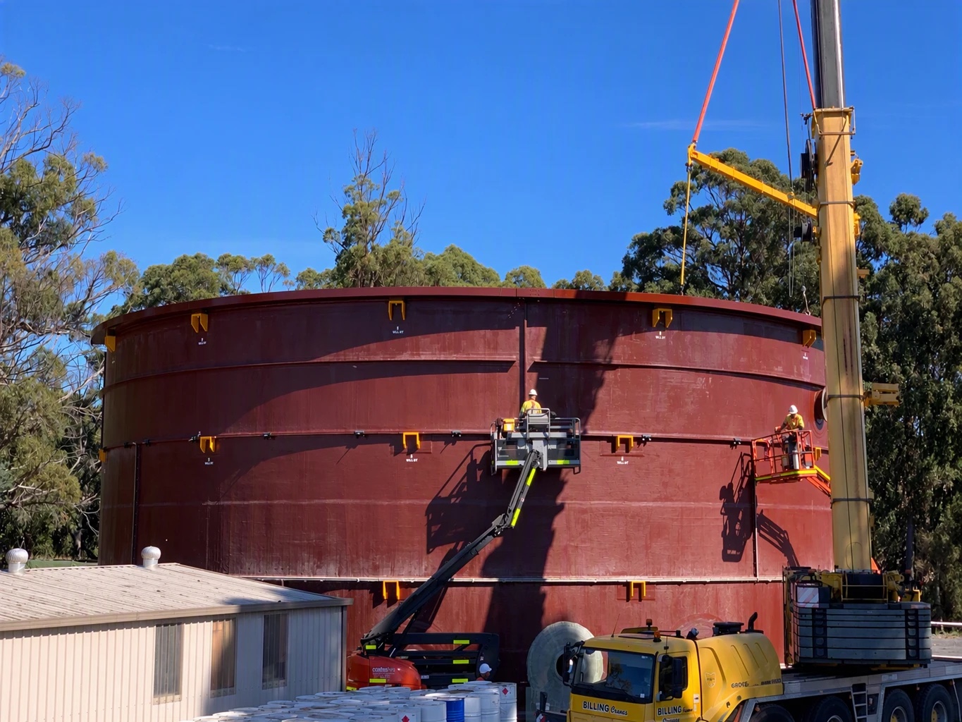 Large FRP tank being installed on site by crane