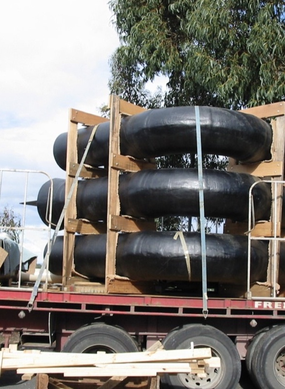 FRP pipe bends strapped to a truck for delivery