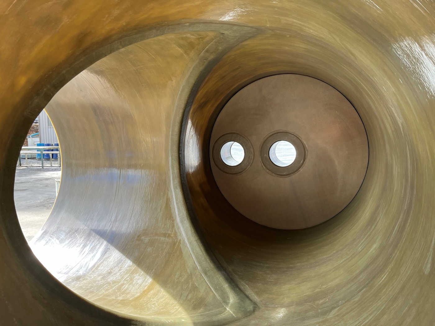 Inside a large FRP pipe section showing the smooth laminate surface