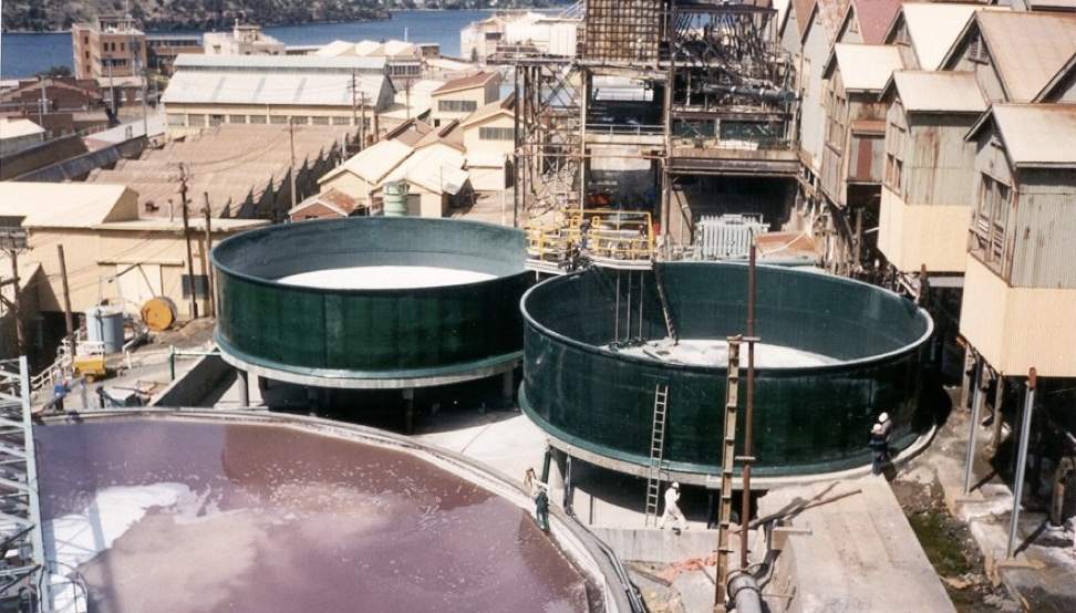 Two green FRP tanks installed at an industrial site